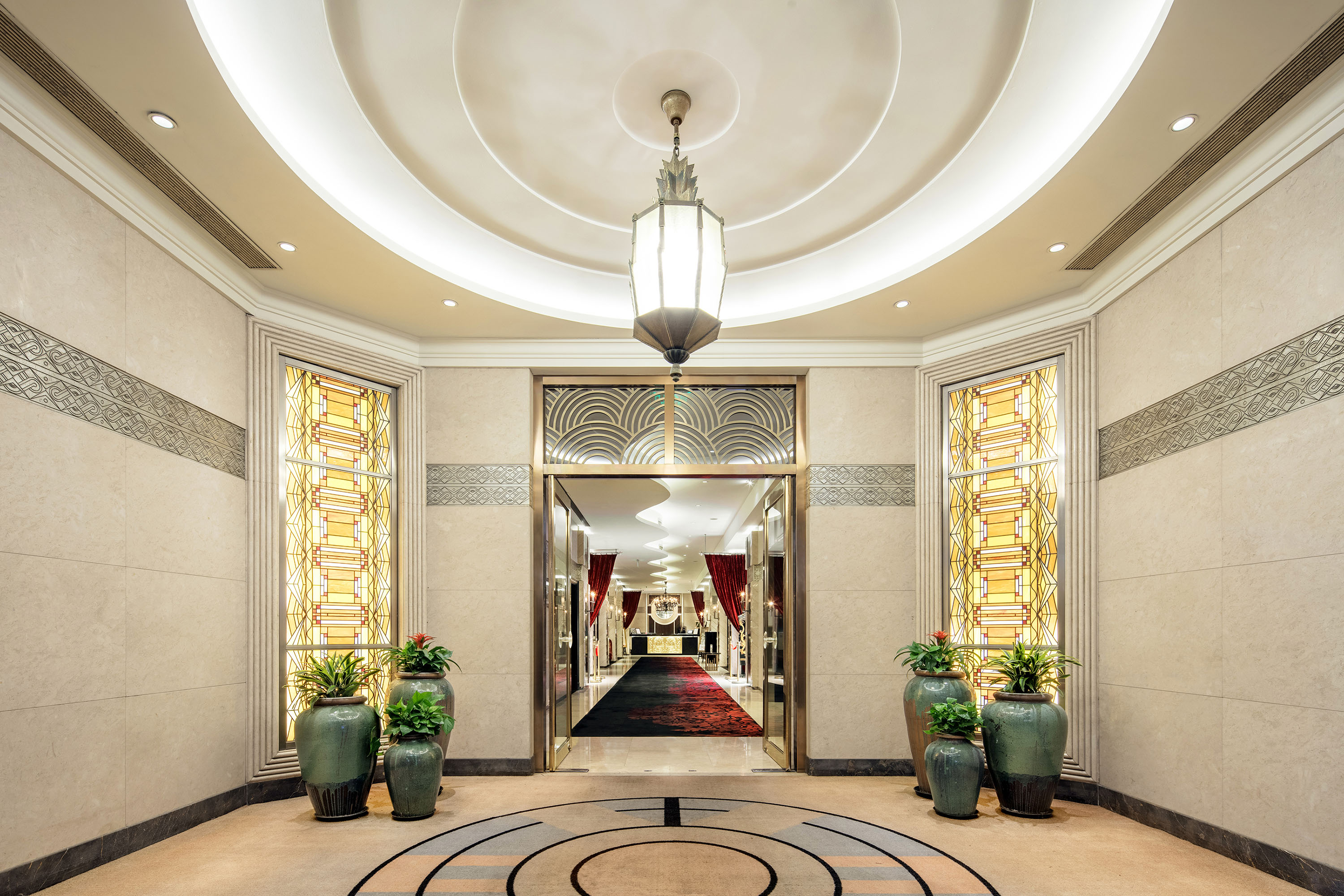 a hallway with a large doorway and plants