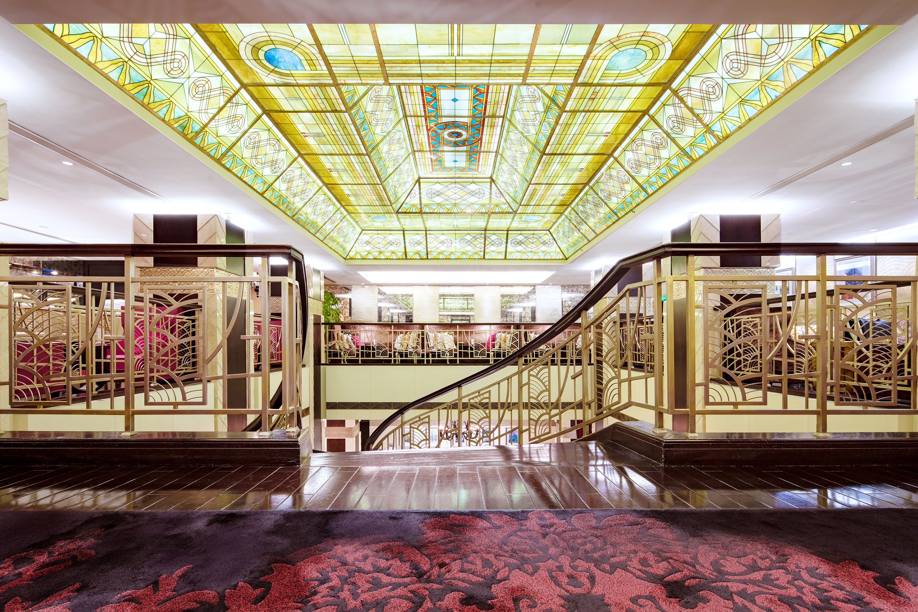 a staircase with stained glass ceiling