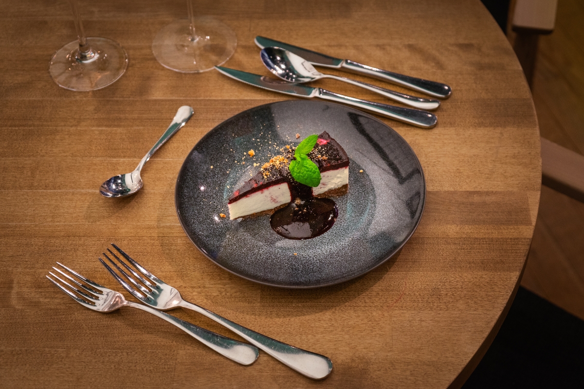 a plate of dessert with a slice of cake on it
