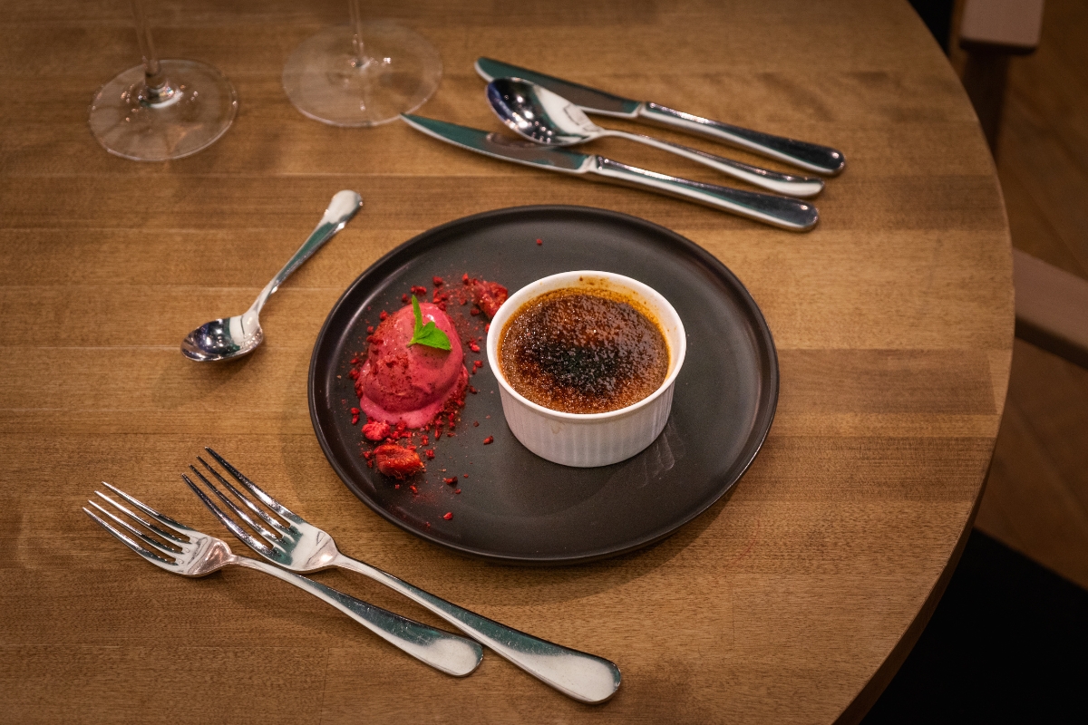 a plate with dessert on it and silverware on a table