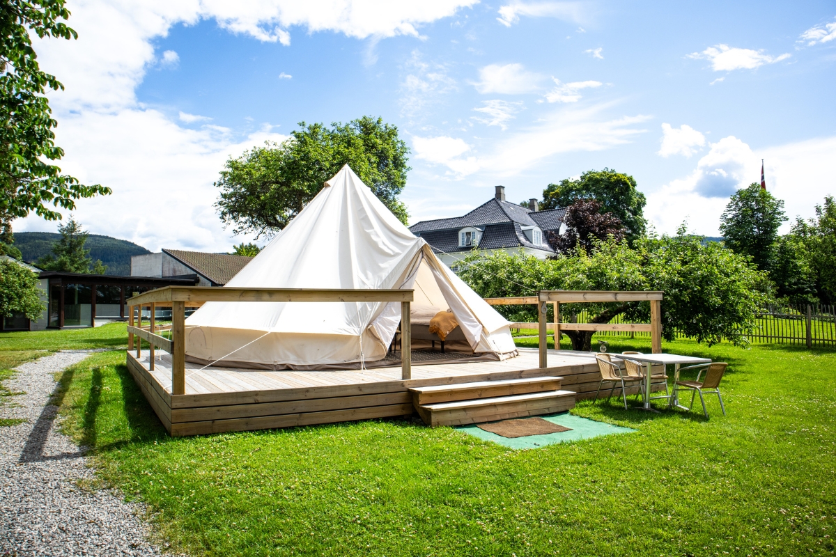 a white tent on a wooden deck
