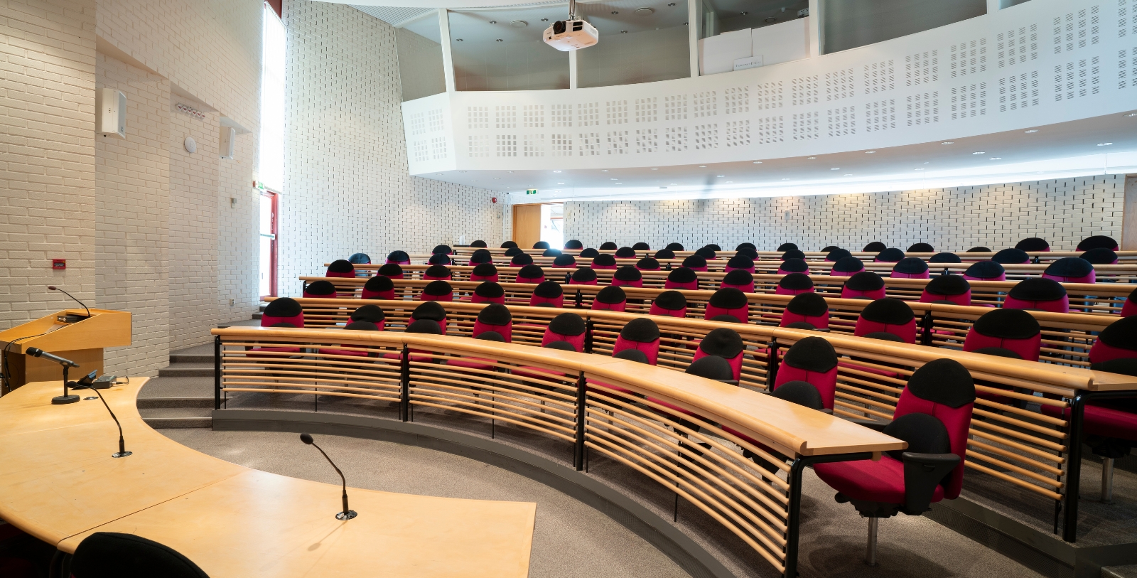 a room with rows of chairs and a podium