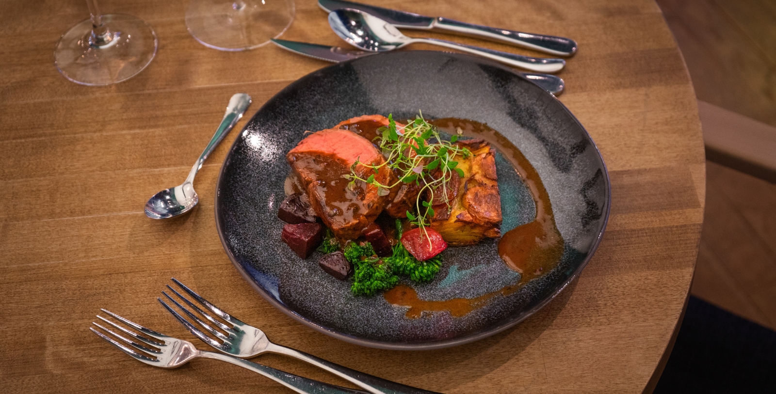 a plate of food with silverware on a table