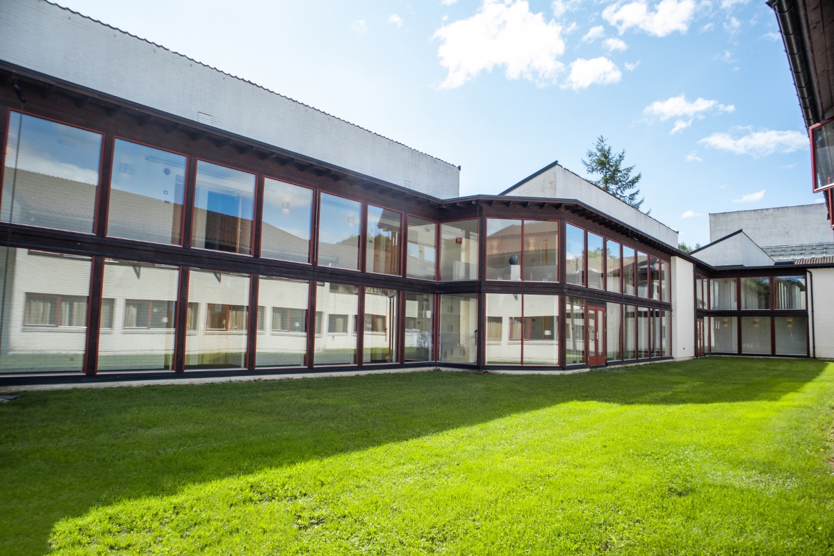 a building with glass windows and grass