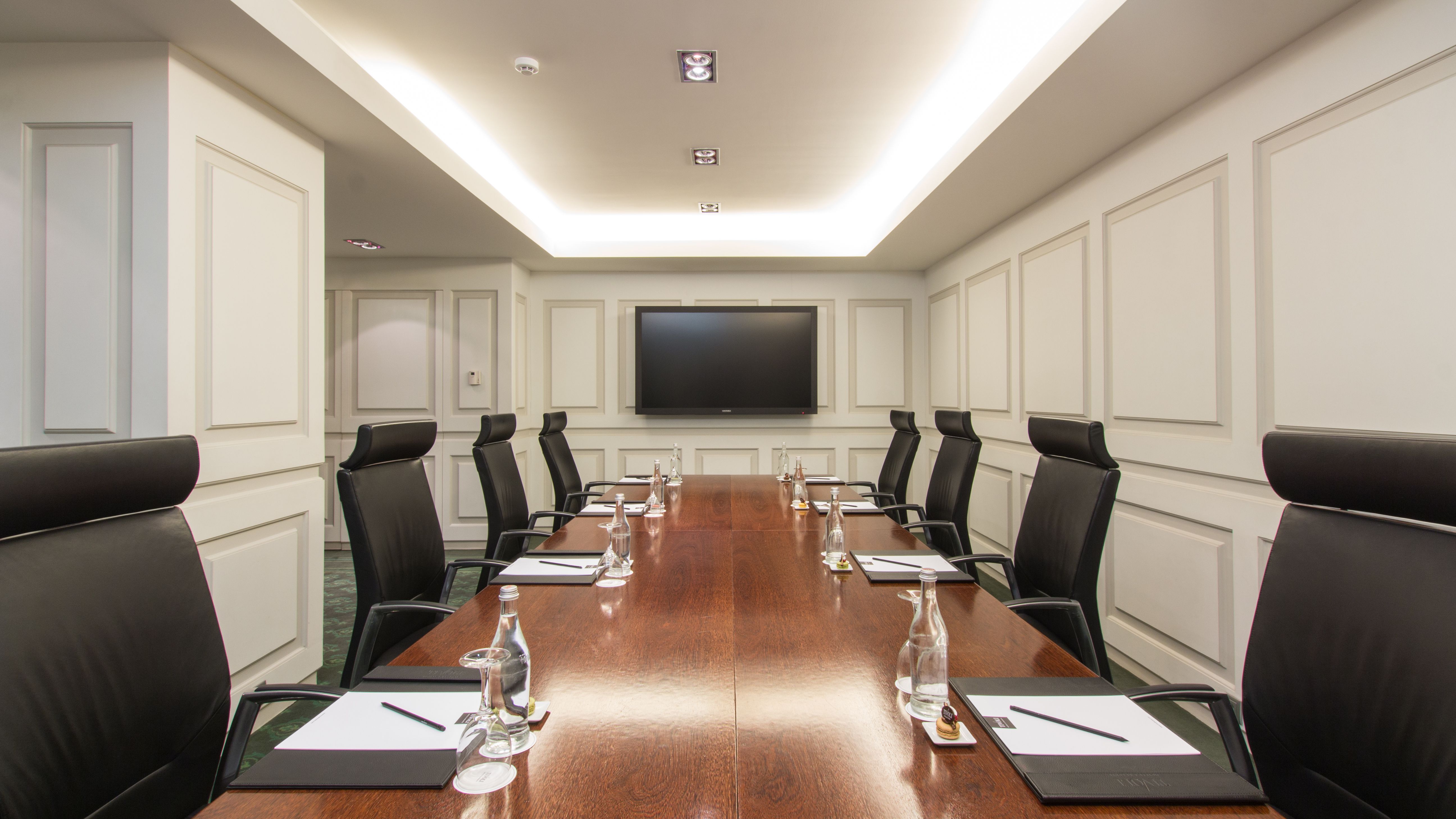a conference room with a large table and chairs