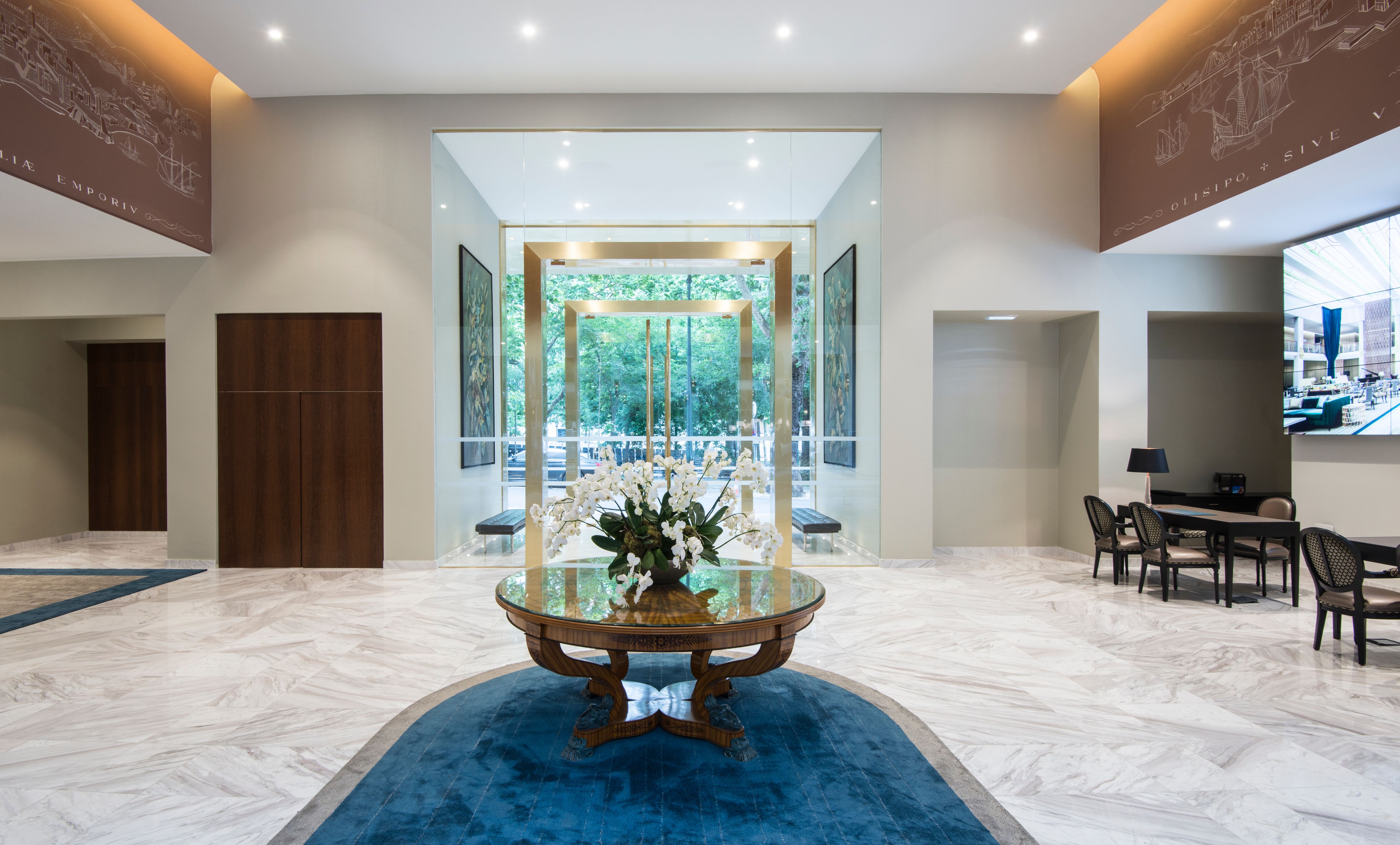 a glass door with a table and chairs in a room