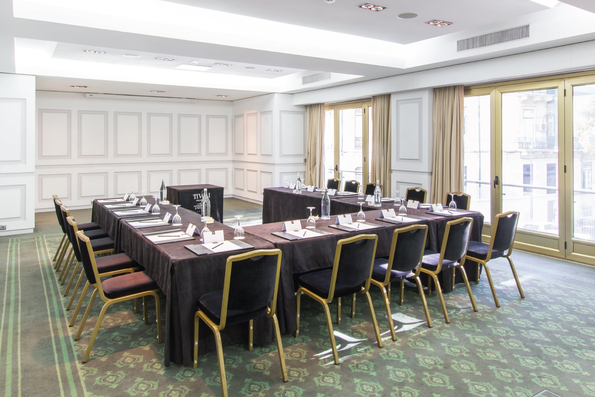 a room with a long table and chairs