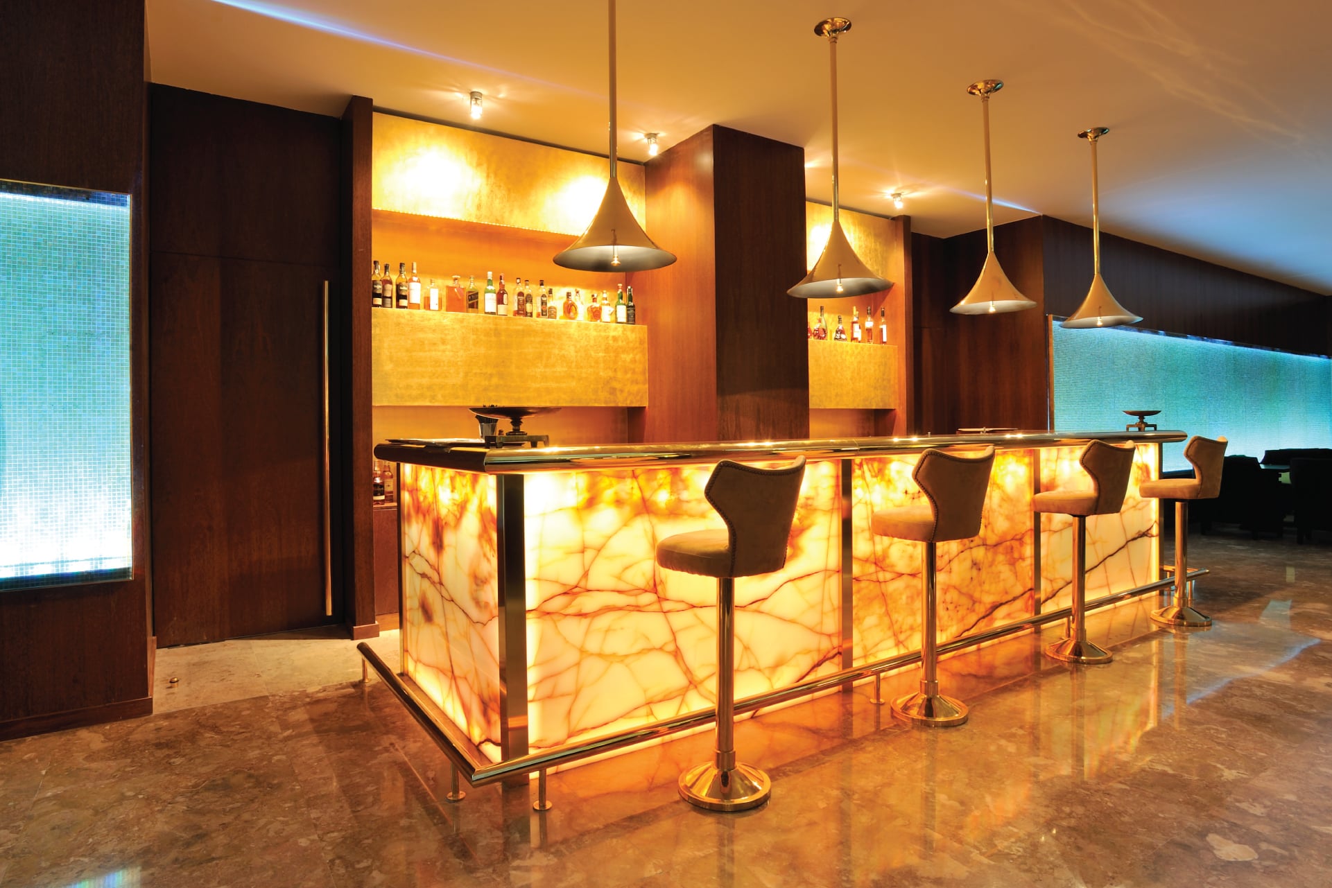 a bar with lights and stools