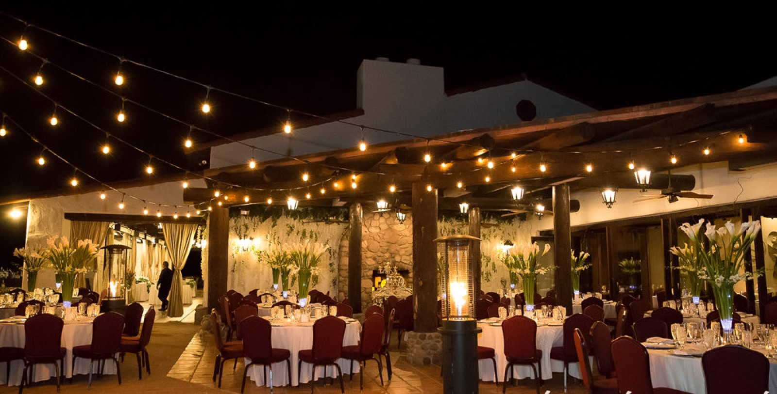 a outdoor dining area with tables and chairs