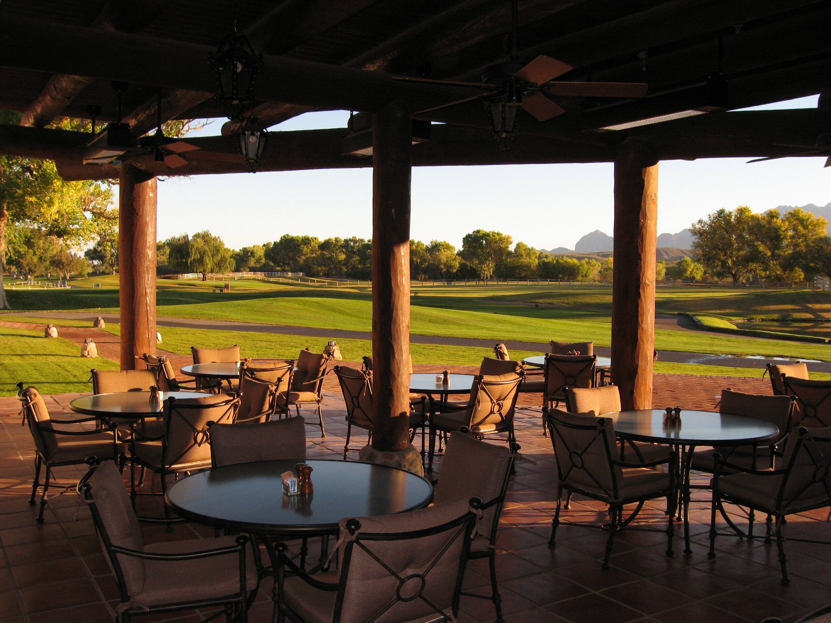 a patio with tables and chairs