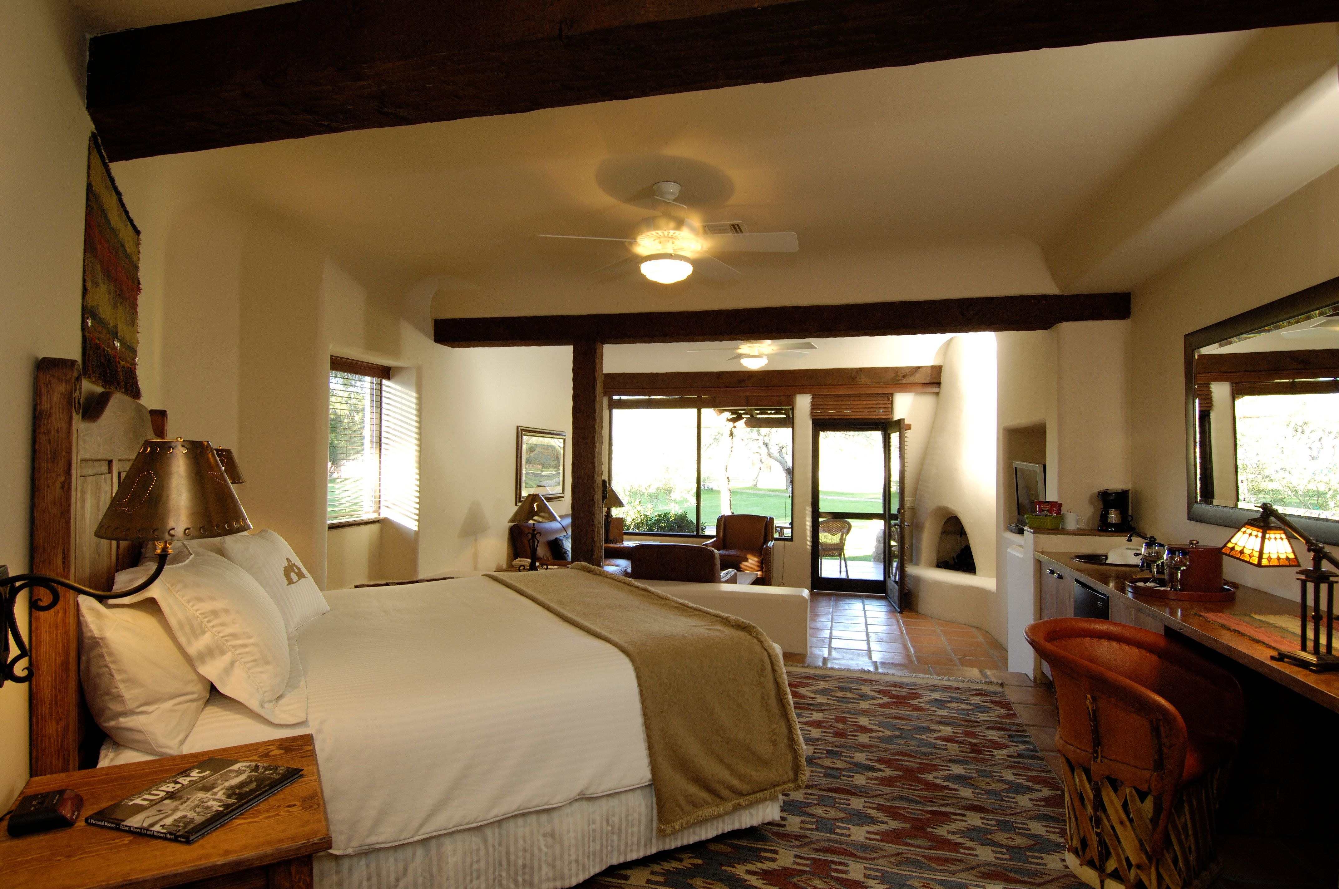 a bedroom with a large bed and a fireplace