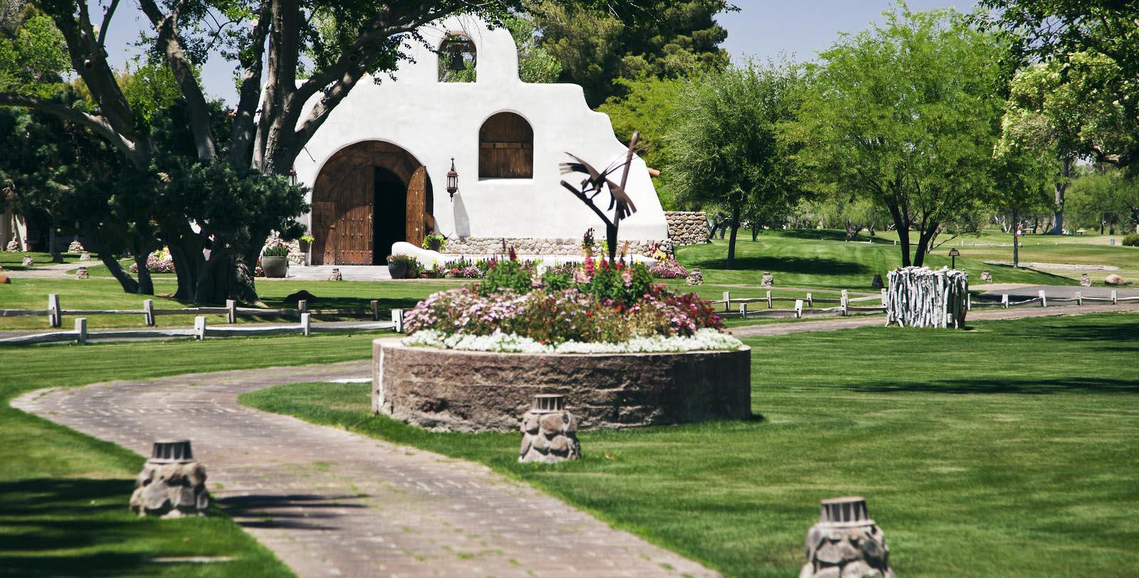 a white building with a white building and a garden