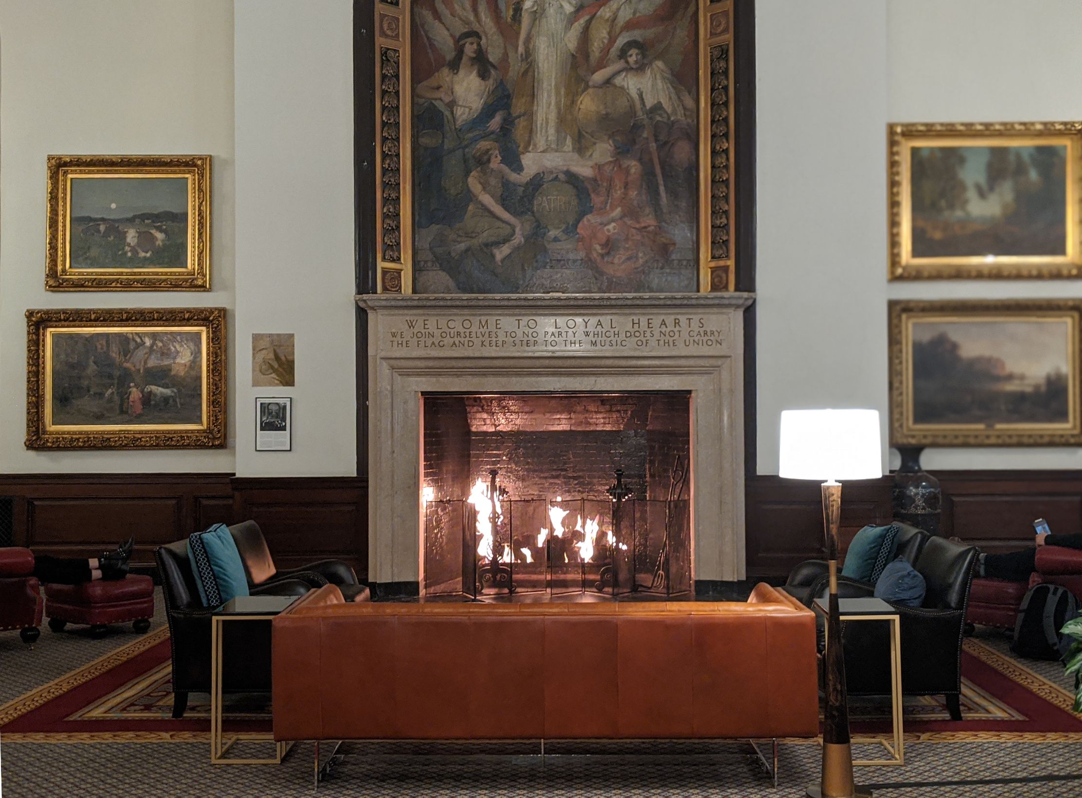 a fireplace in a room with a painting above it