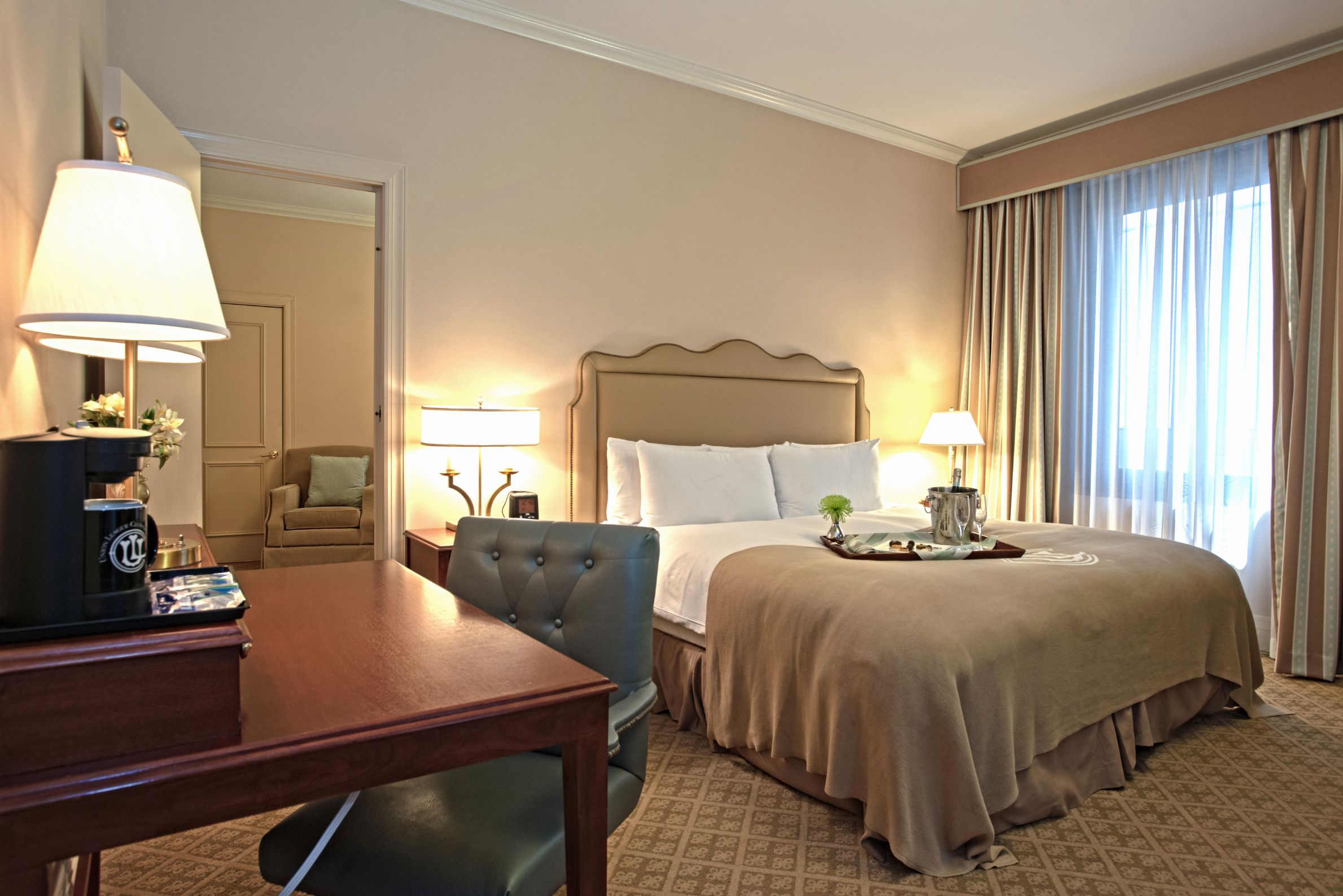 a hotel room with a bed and a desk