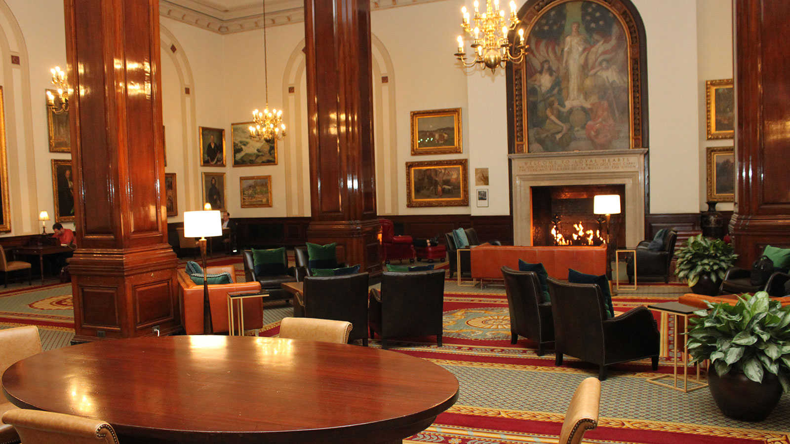 a room with a fireplace and tables