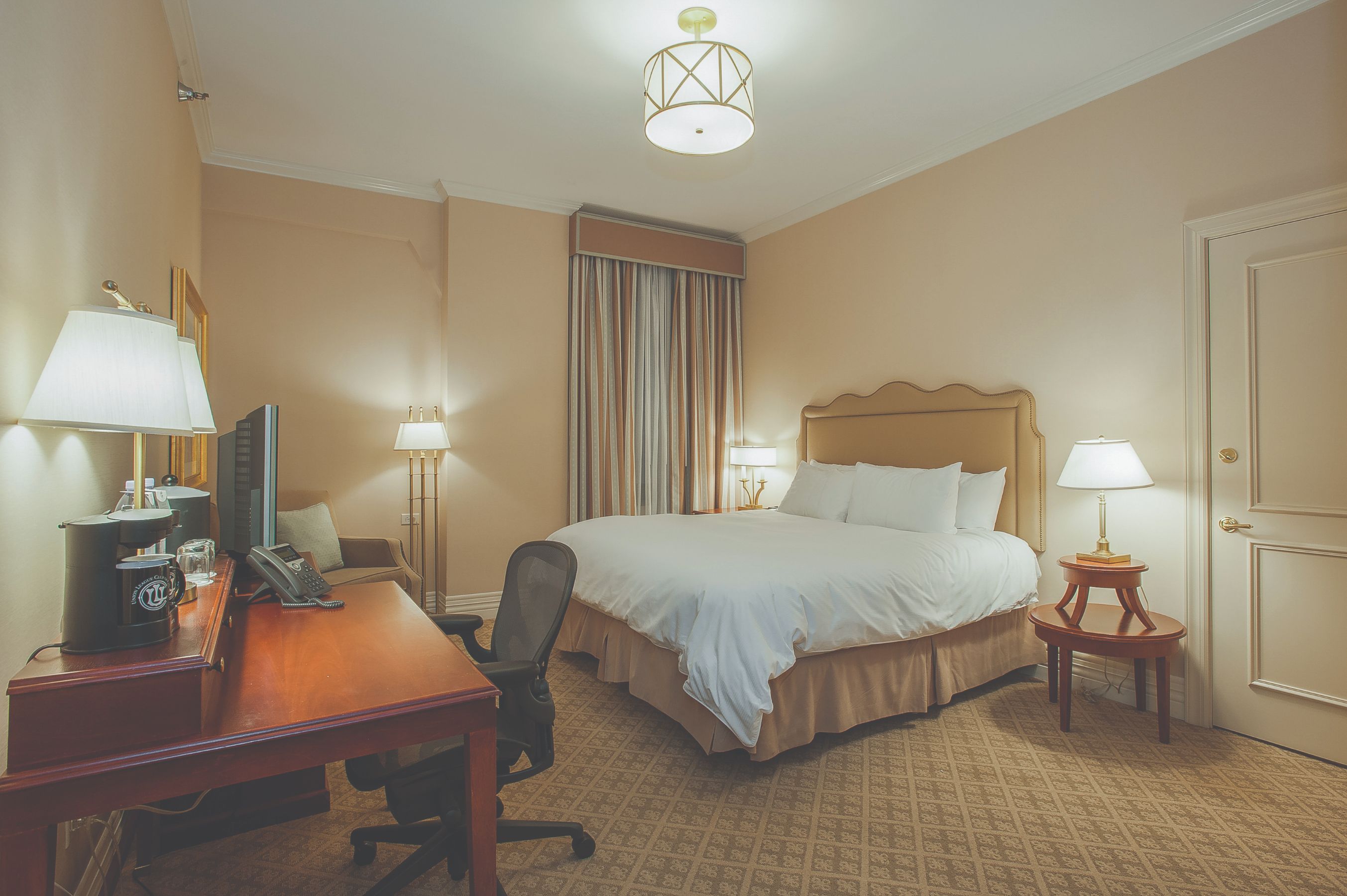 a bedroom with a bed and a desk