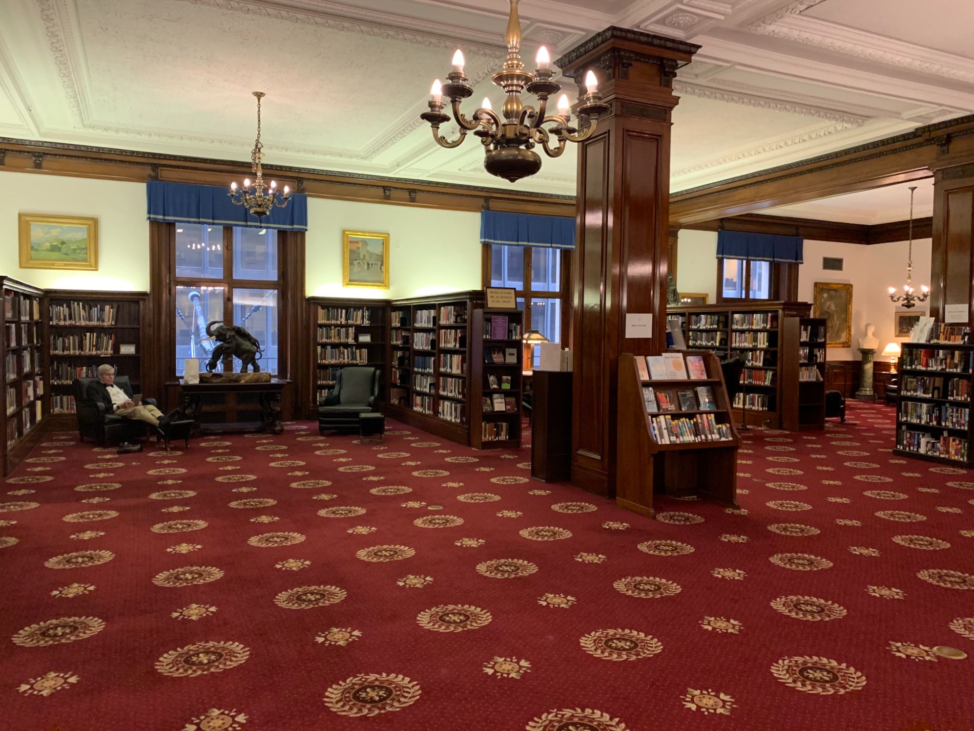a room with red carpet and a chandelier