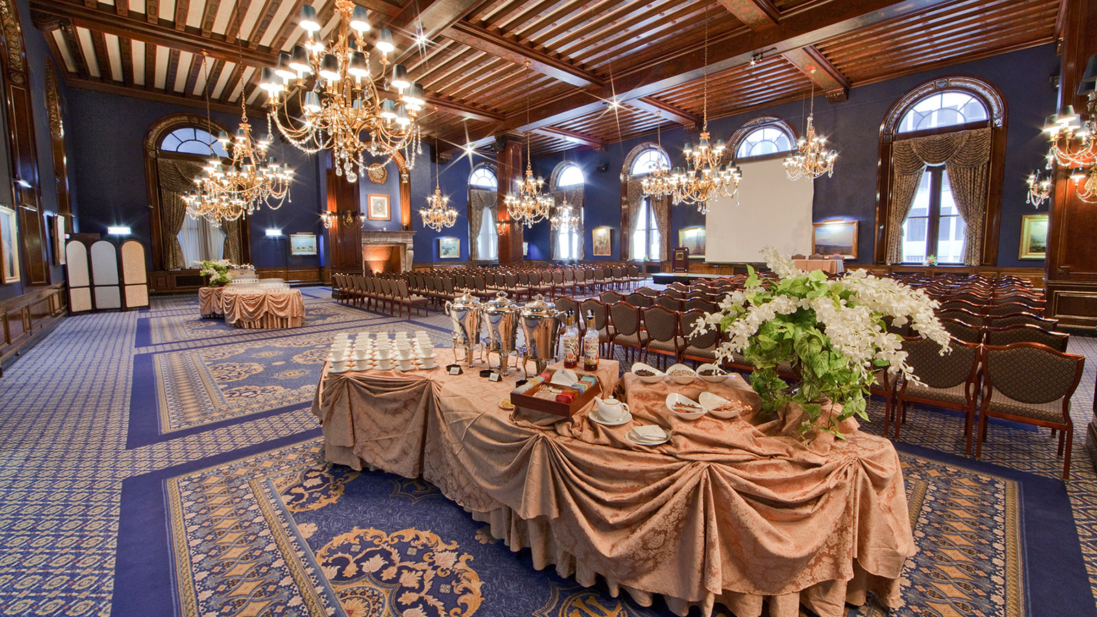 a large room with a large table with plates and chairs