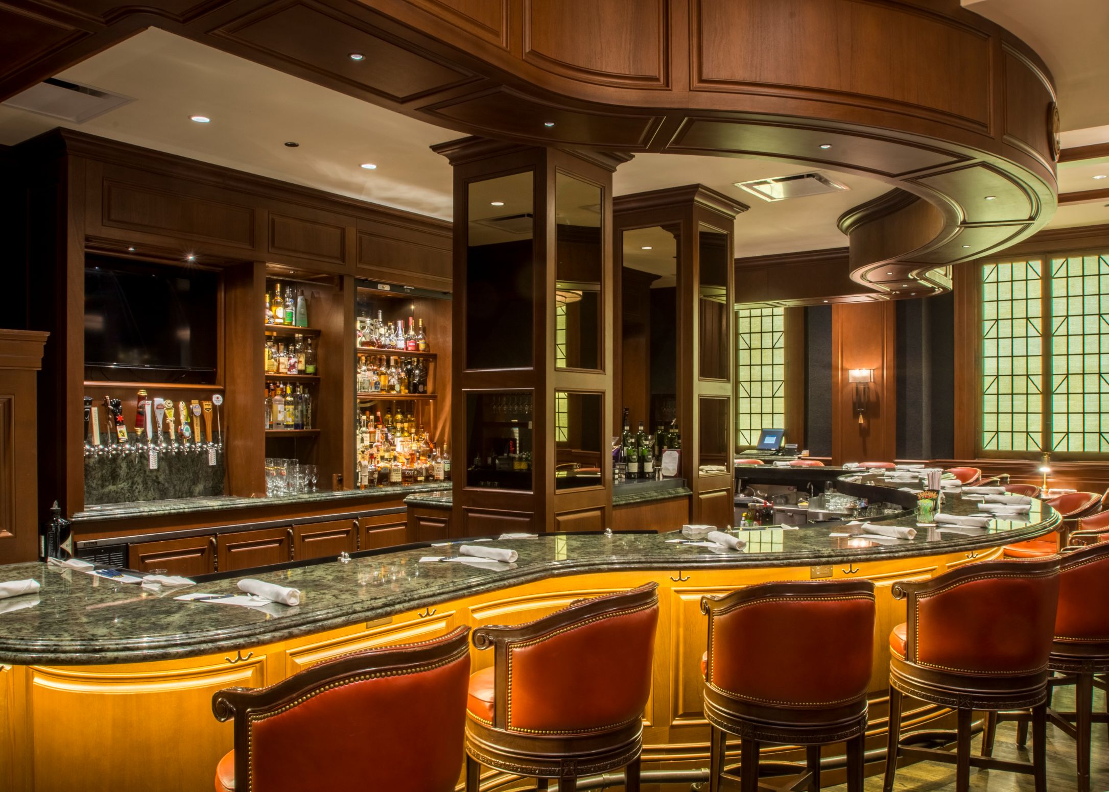 a bar with chairs and a counter