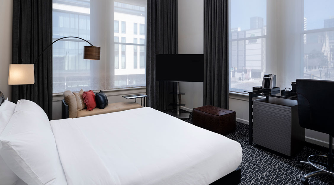 a room with a bed and a television