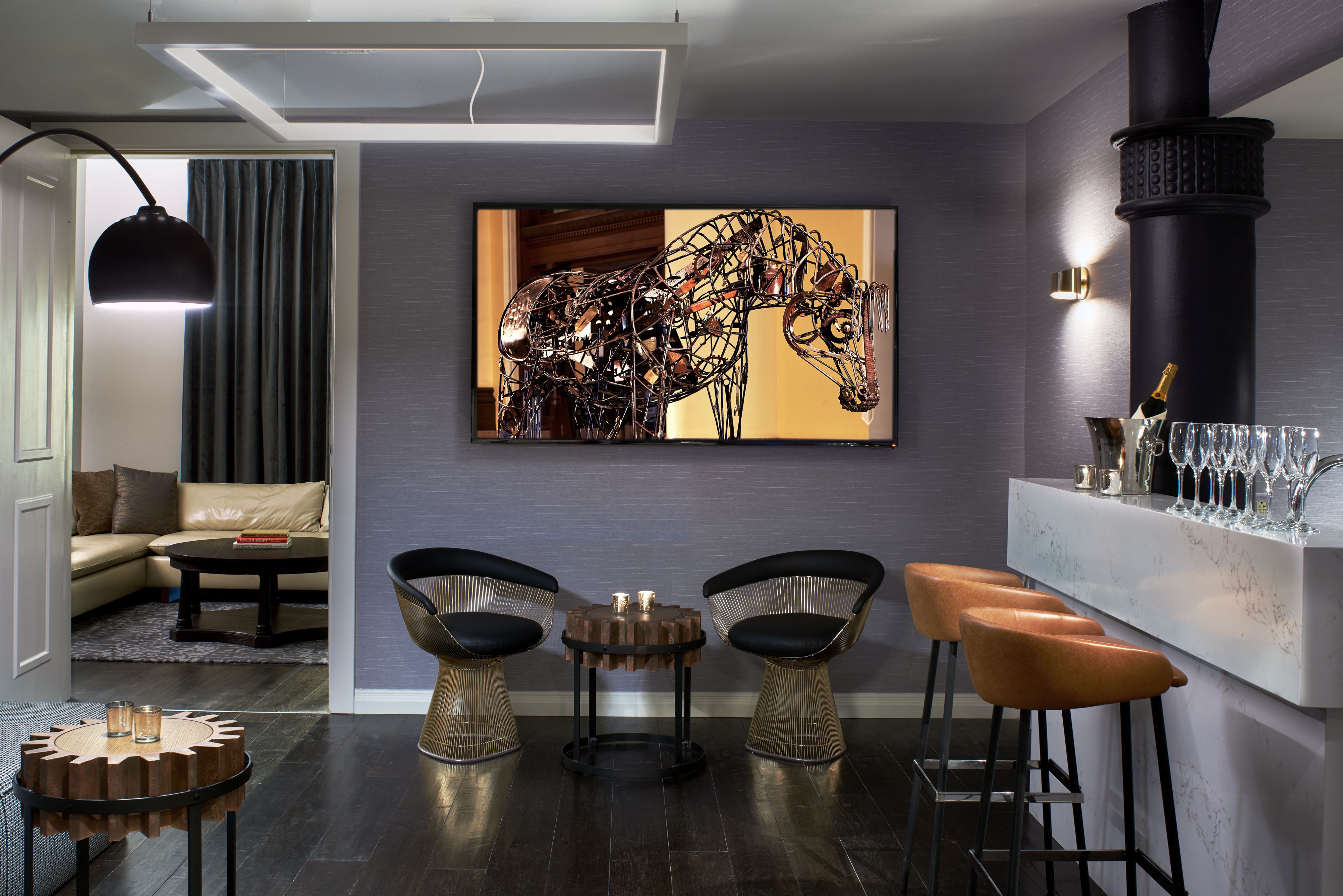 a room with a tv and chairs