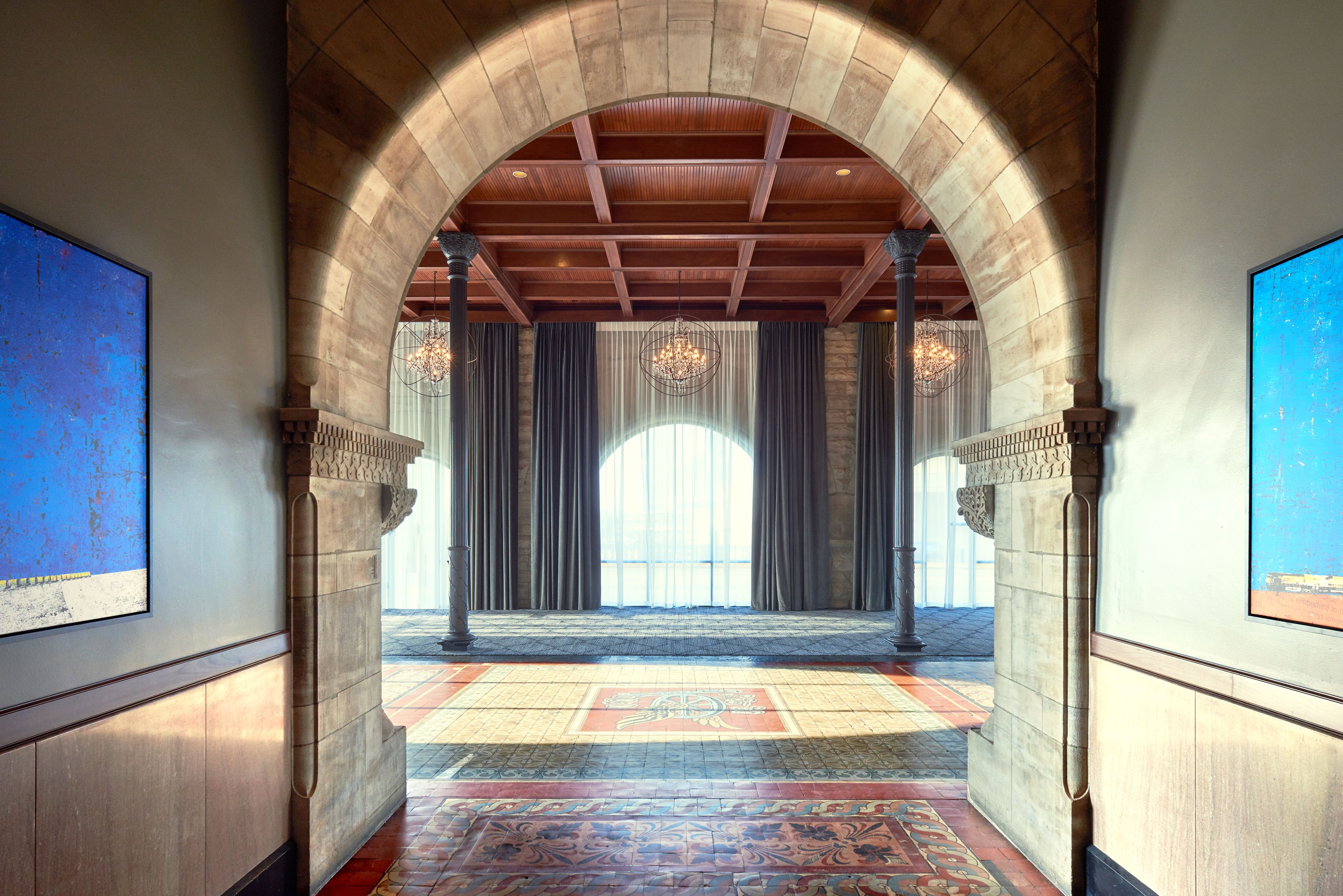 a large room with a large archway and a carpeted floor
