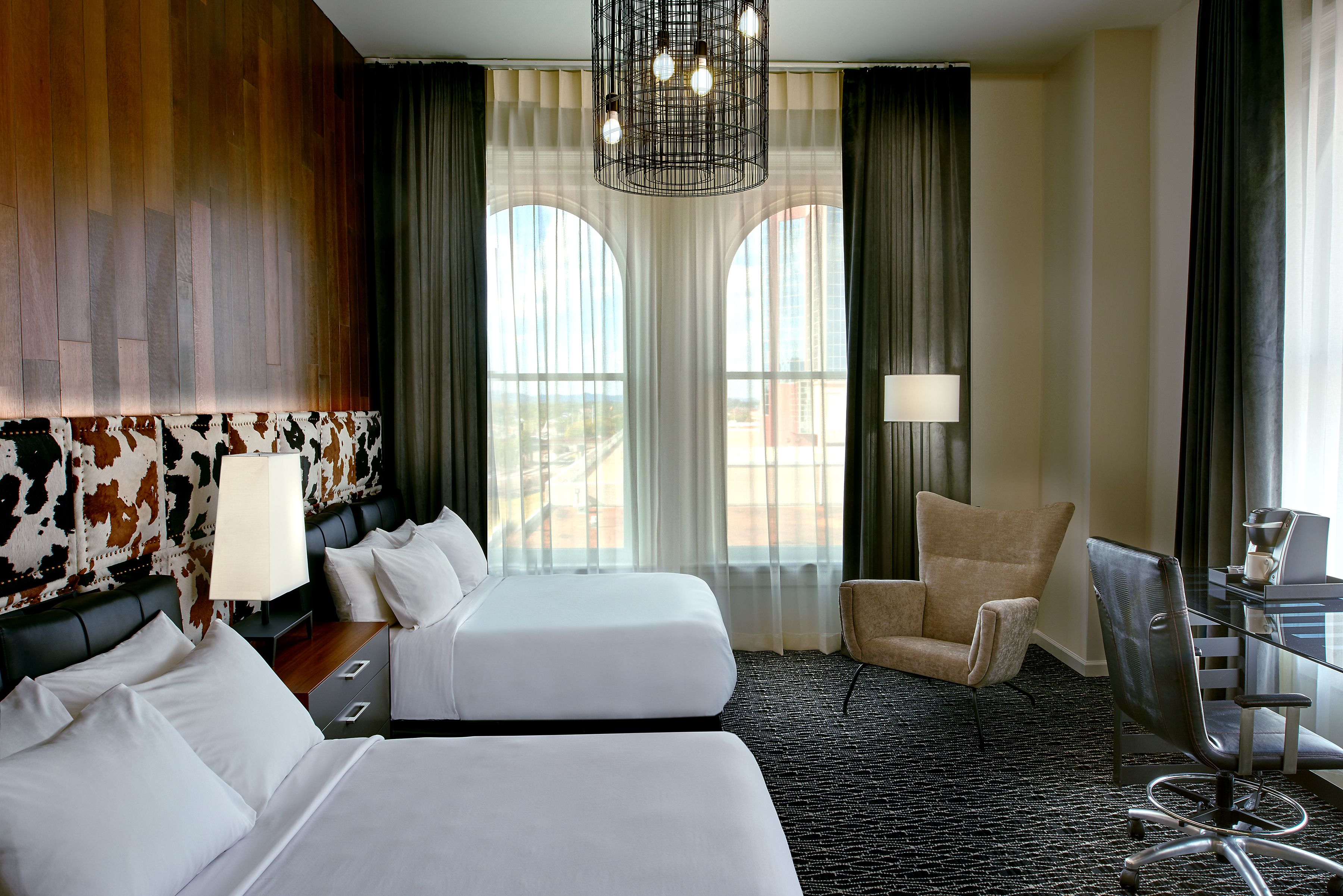 a room with two beds and a chair