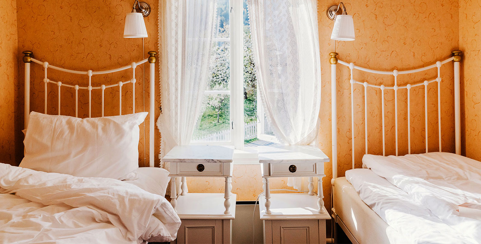 a bedroom with two beds and a window