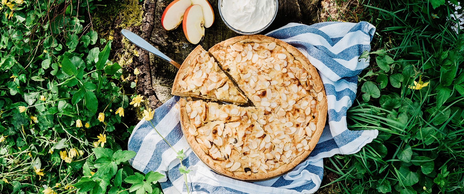 a pie with almonds on a towel