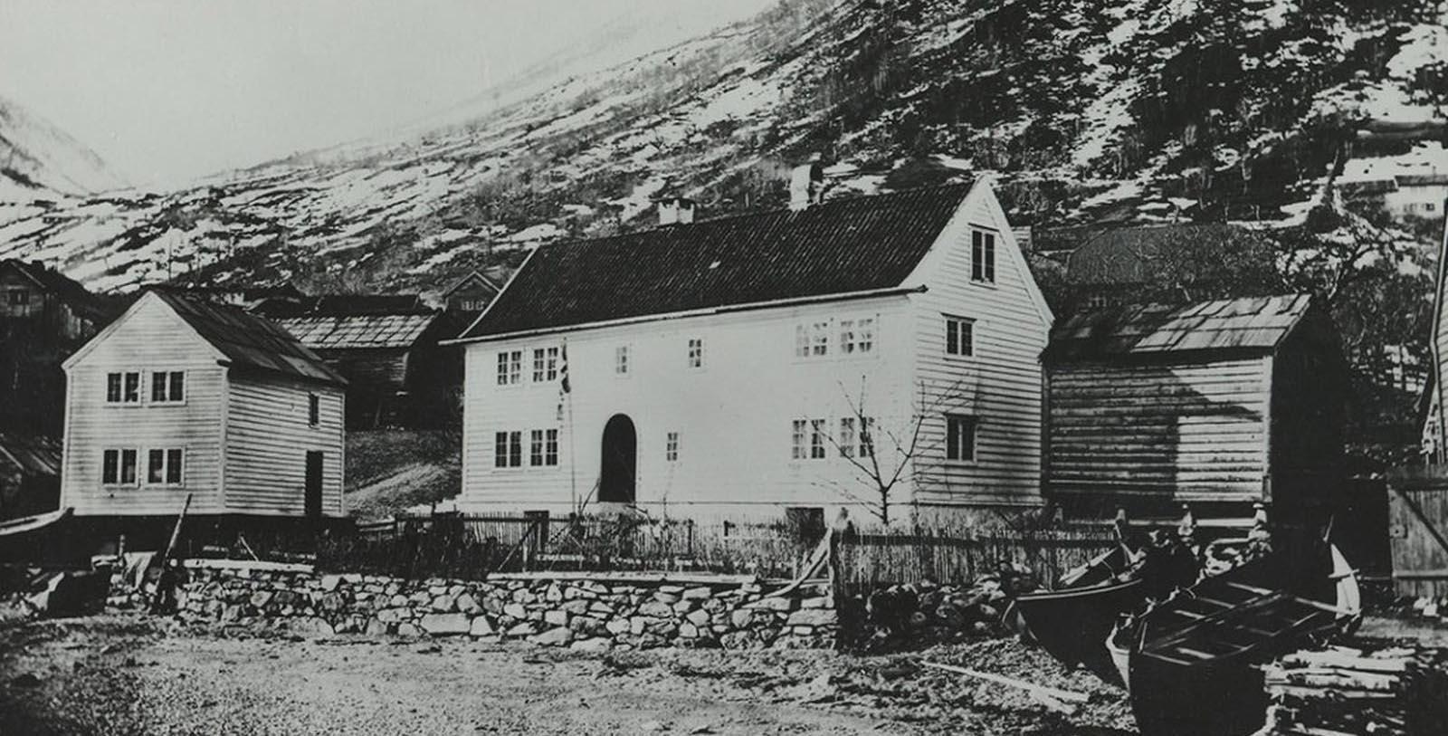 a house with a fence and a fence in front of it