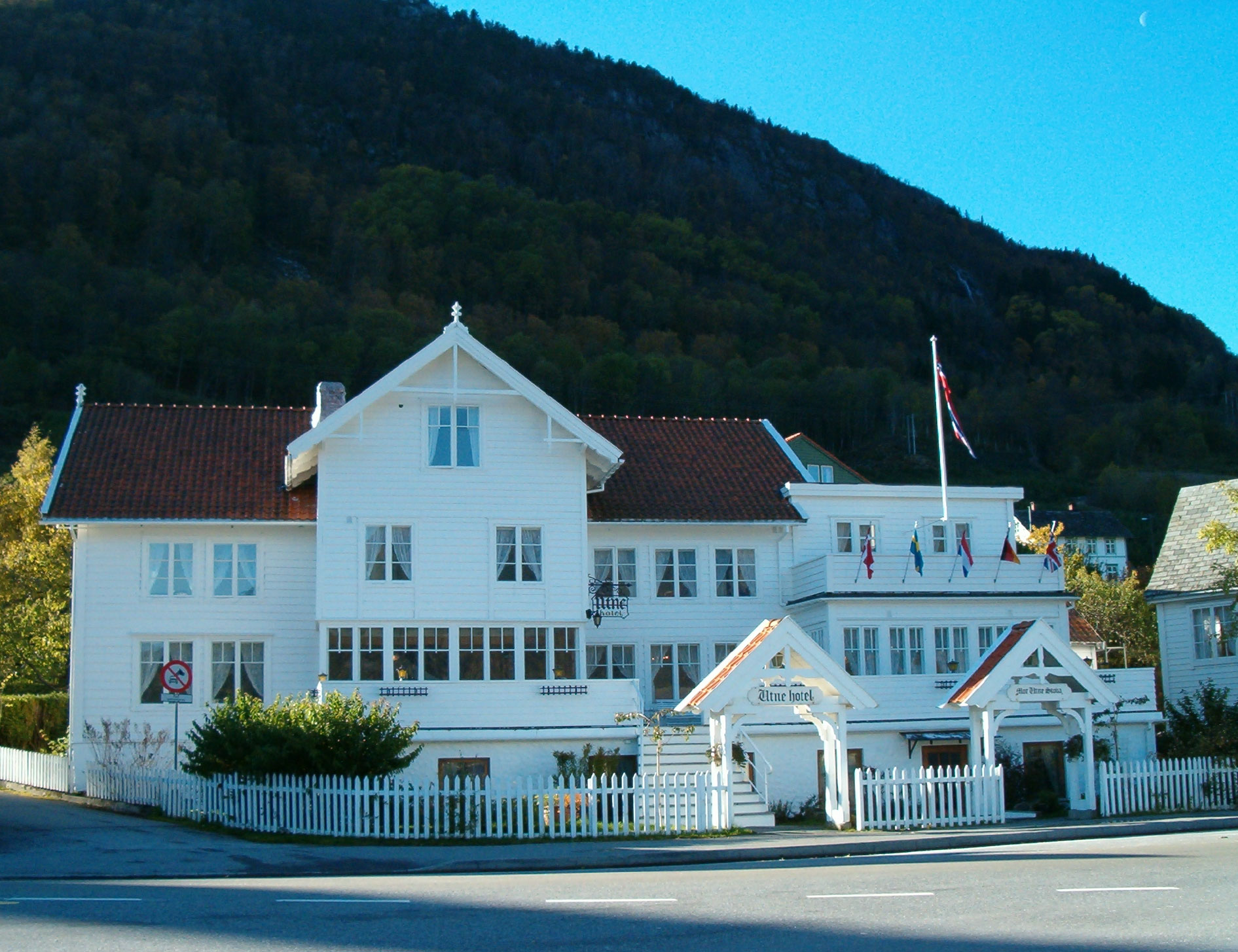 a white building with a white fence and a white picket fence