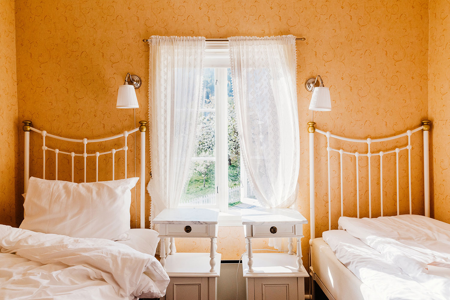 a bedroom with two beds and a window