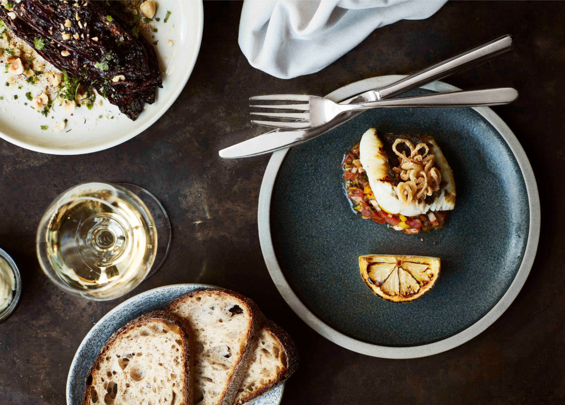 a plate of food and a glass of wine