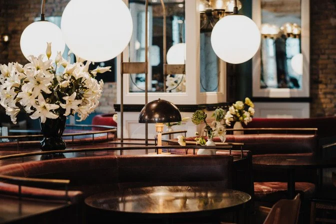 a table with white flowers and a lamp