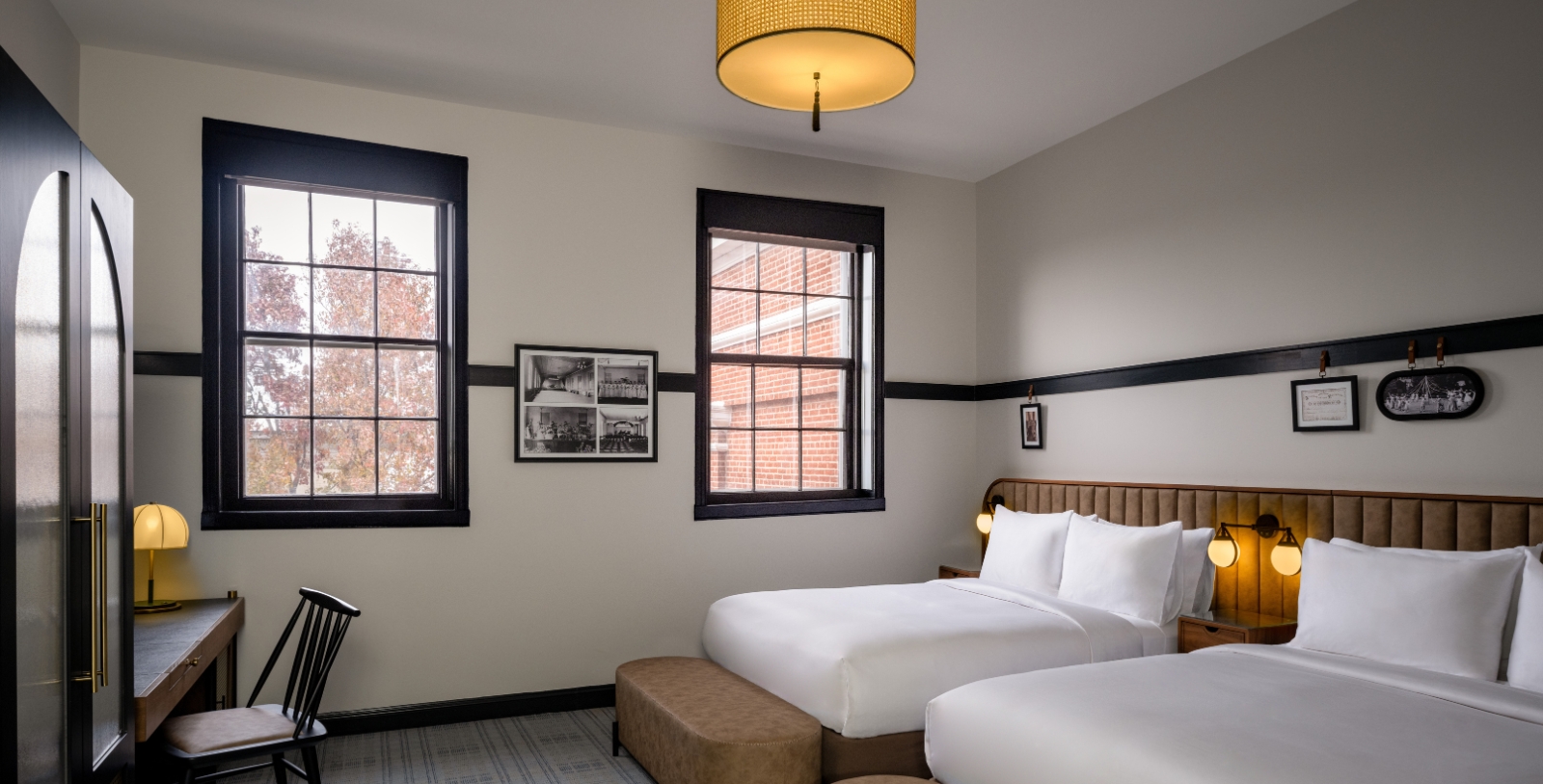 a room with two beds and a lamp