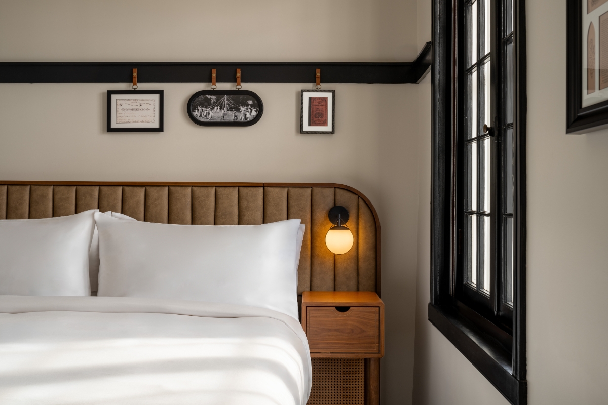 a bed with a light on the side of the bed