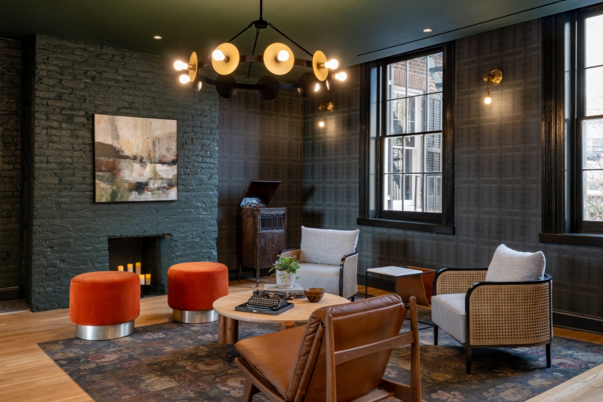 a room with a fireplace and chairs