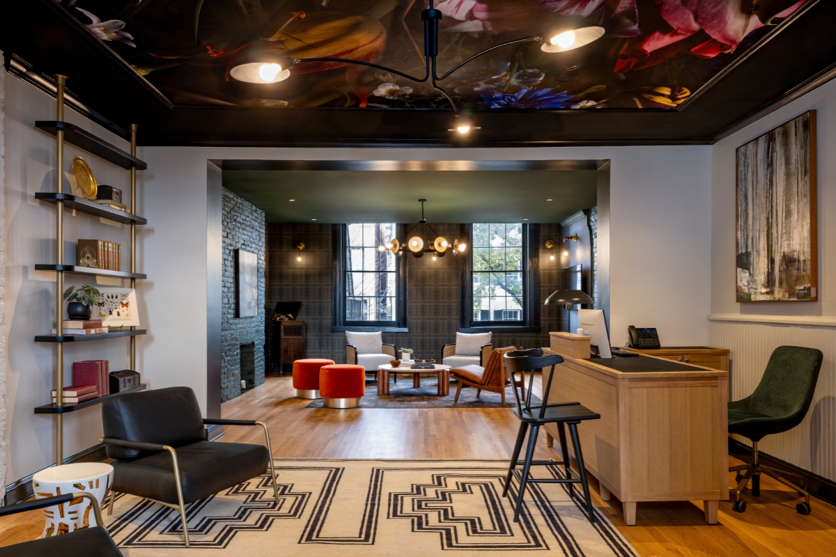 a room with a black and white rug and chairs