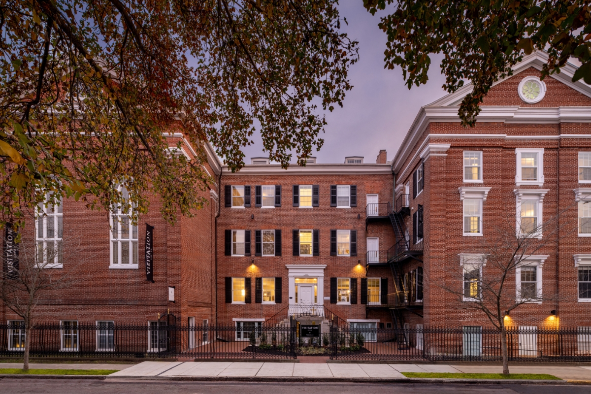 a building with a fence and trees