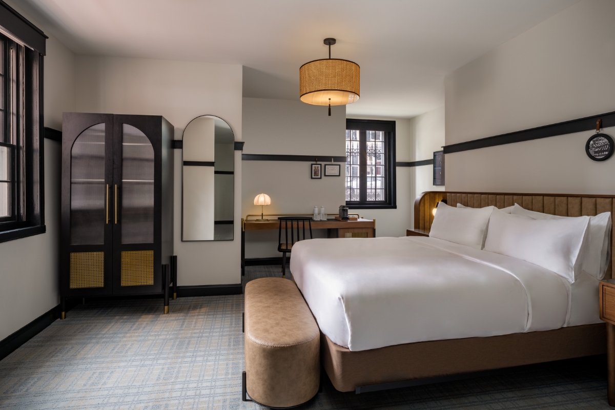 a bedroom with a bed and a mirror