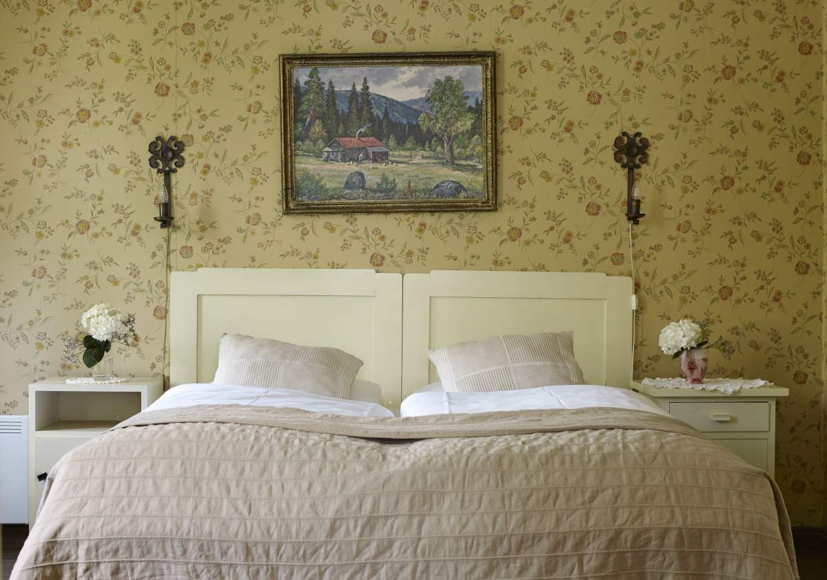 a bed with a painting on the wall