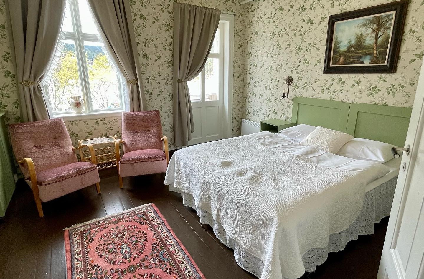a bedroom with a bed and chairs