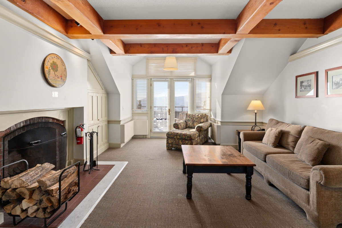 a living room with a fireplace and couches