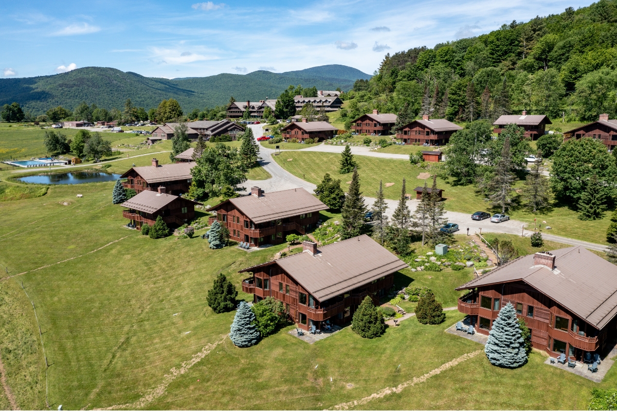 a group of houses in a grassy area