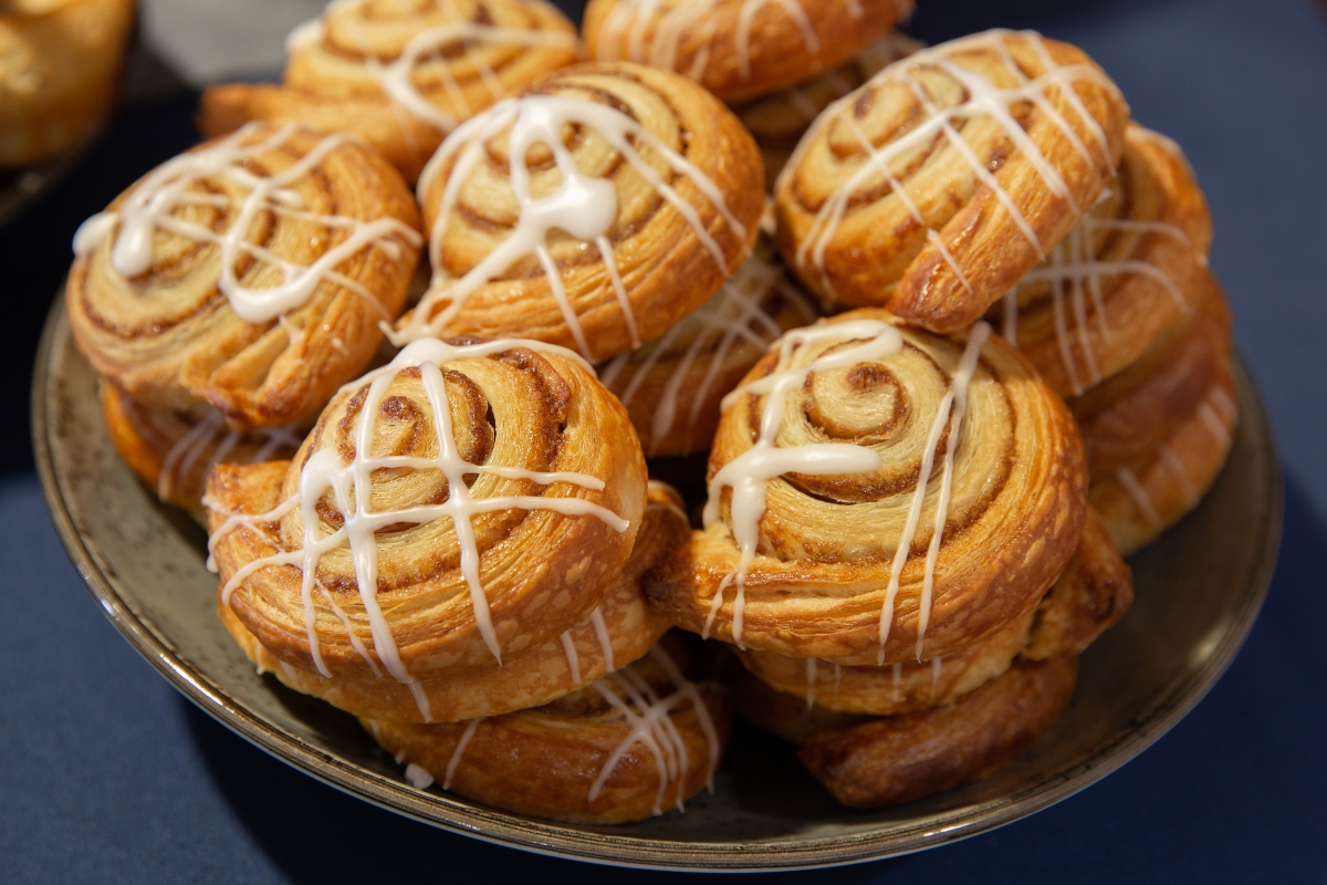 a plate of pastries with white frosting