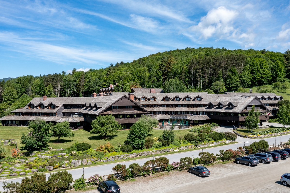 a large building with trees and a road