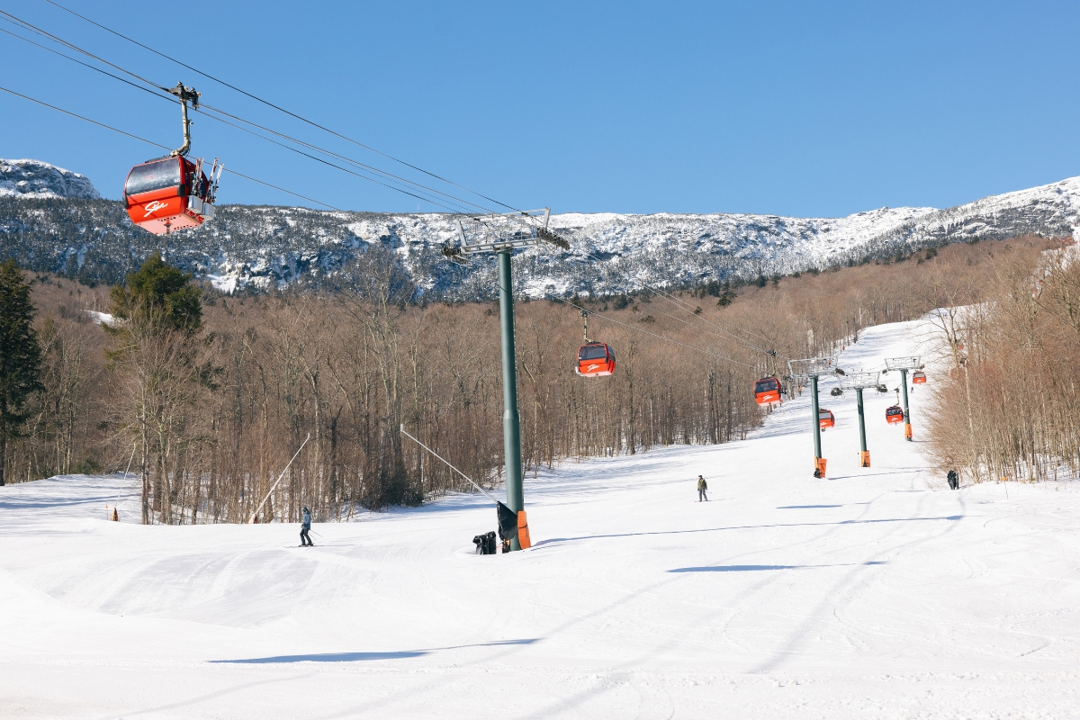 a ski lift going down a snowy hill