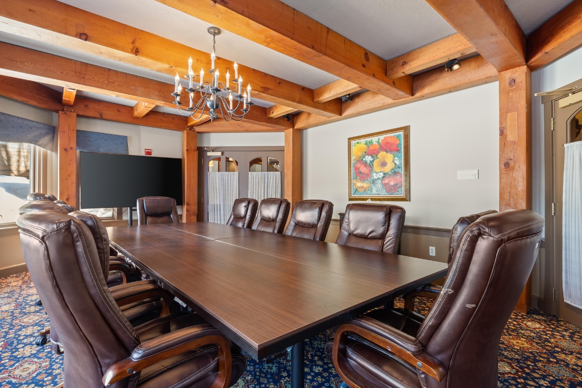 a conference room with a chandelier and chairs