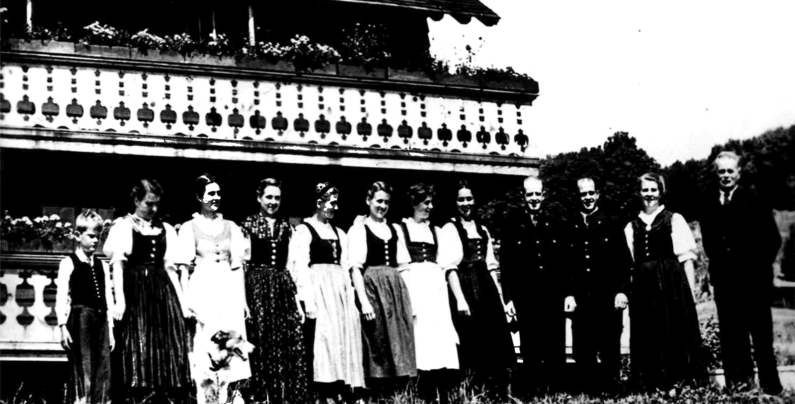 a group of people standing in front of a house