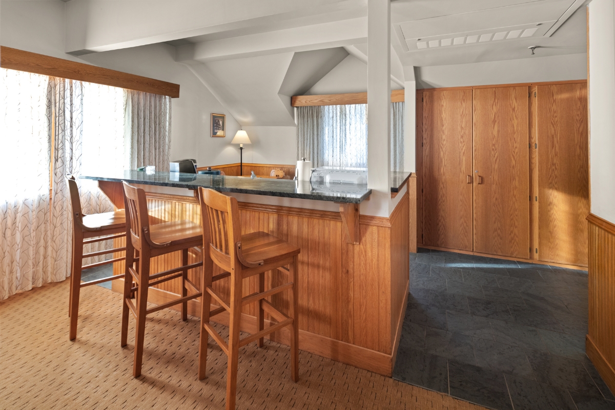 a room with a bar and chairs